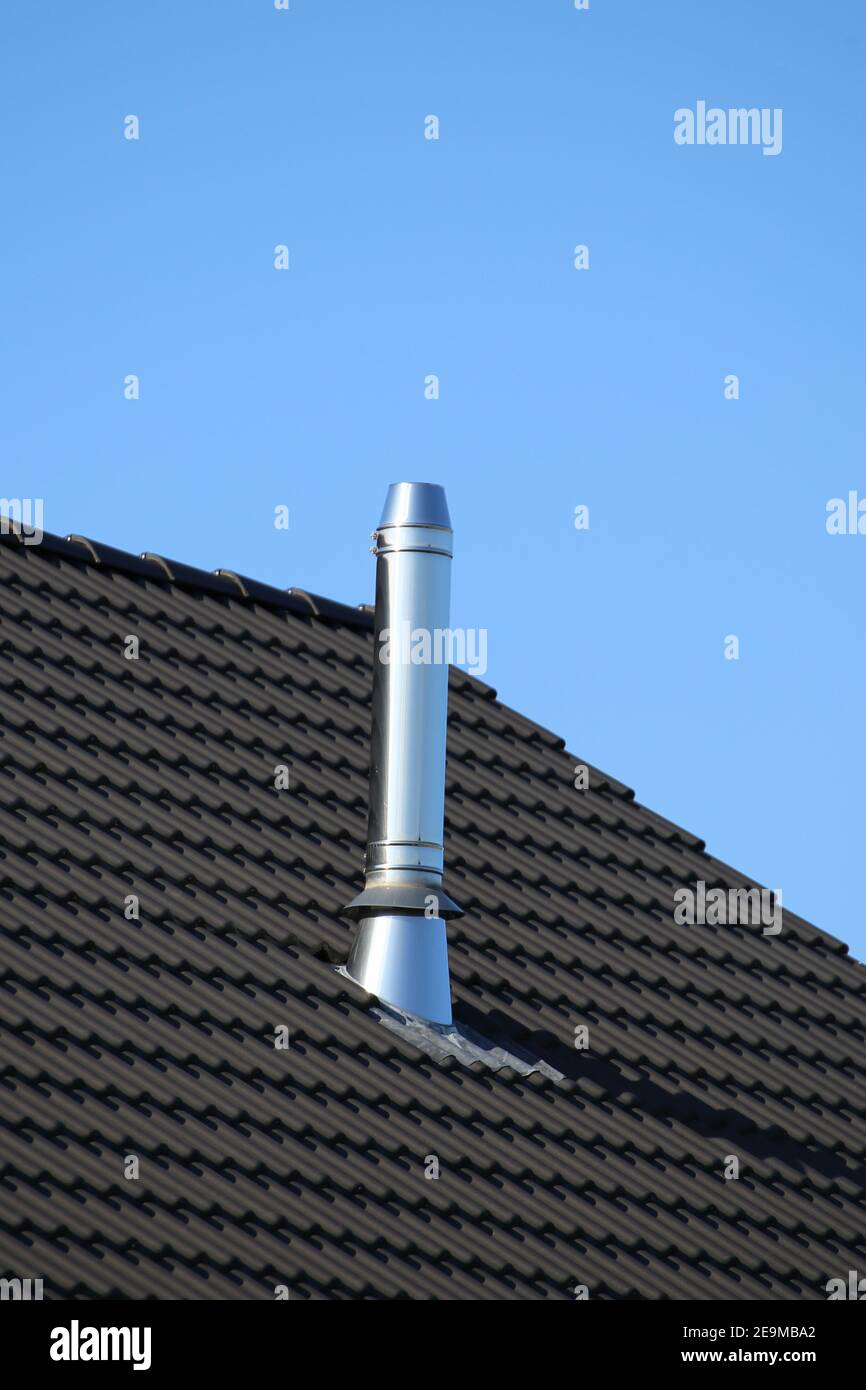 Chimney with stainless steel cladding on a newly covered roof Stock ...