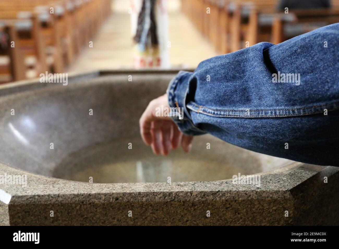 Symbol image: Hand in holy water Stock Photo