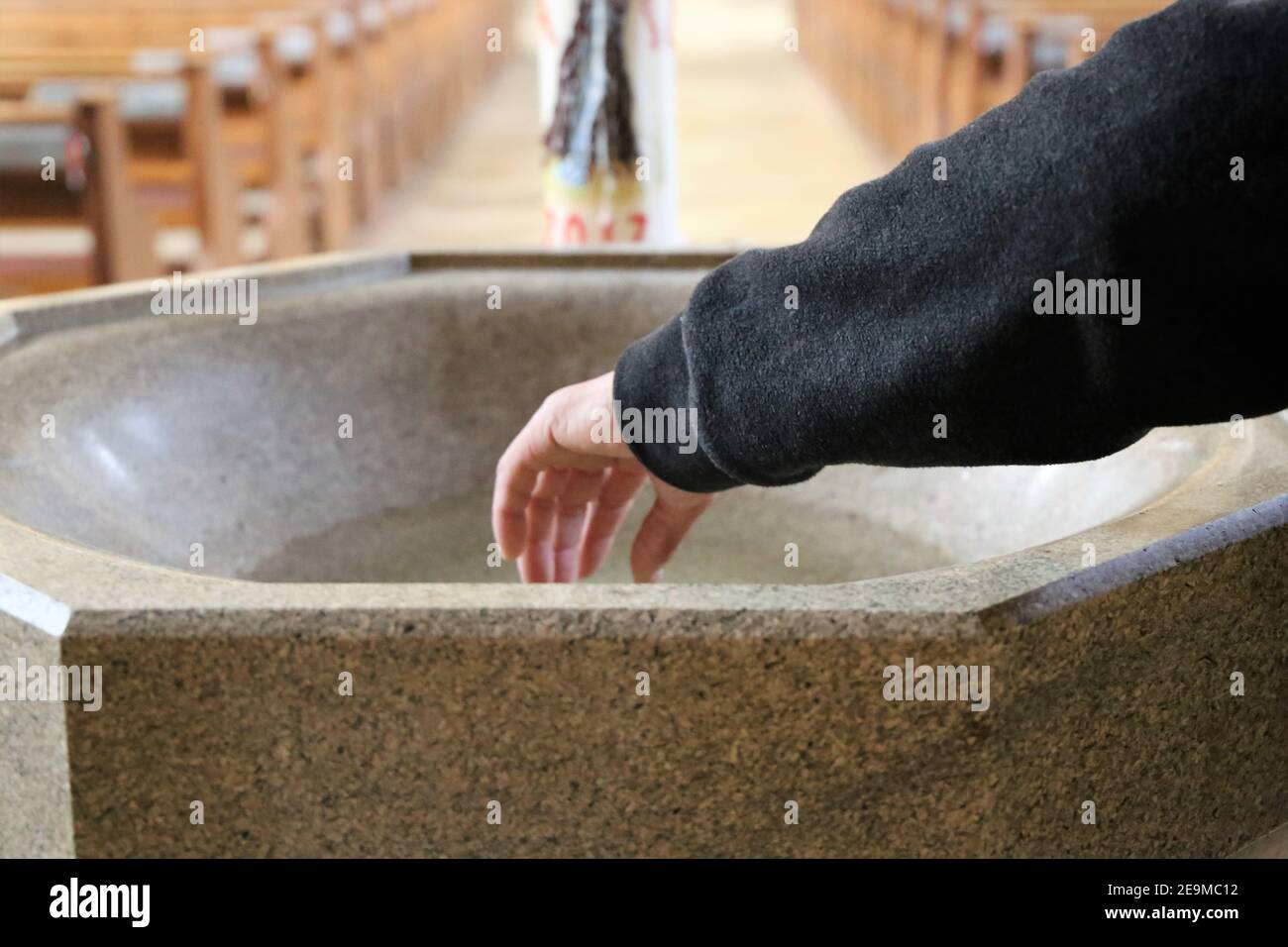 Symbol image: Hand in holy water Stock Photo