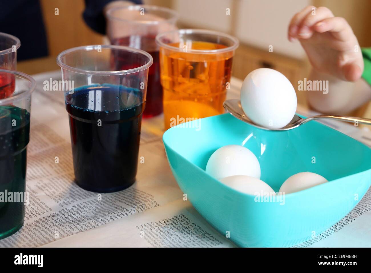 Child colouring easter eggs Stock Photo