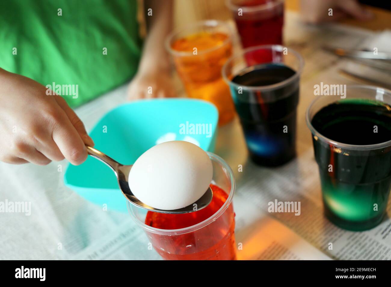 Child colouring easter eggs Stock Photo