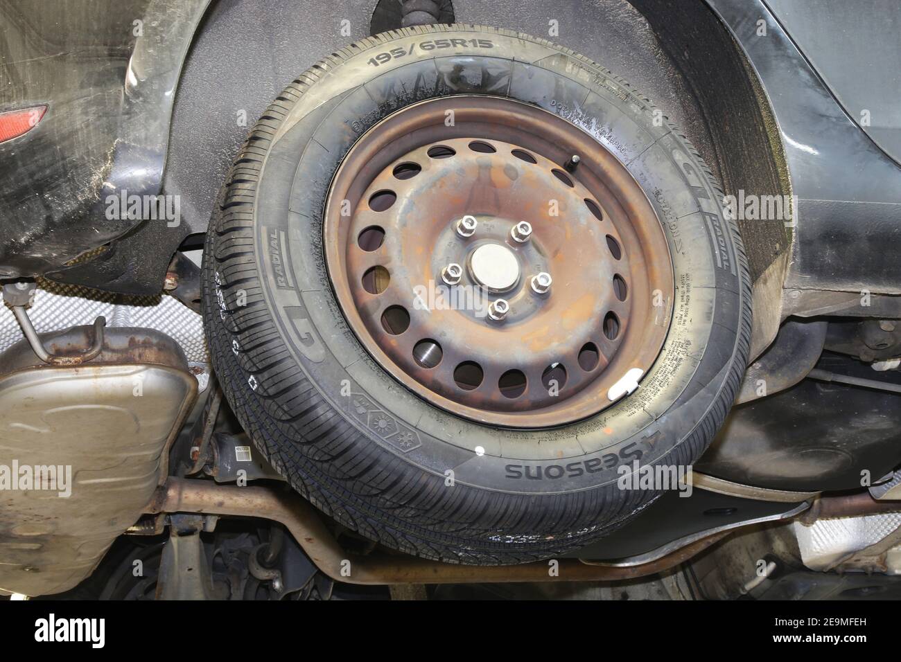 Mounting new all weather tires in the car (editorial Stock