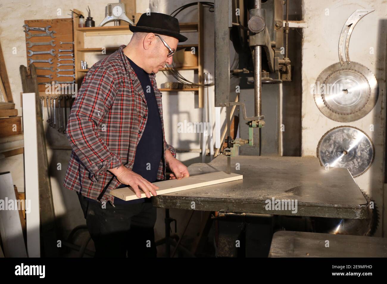 Furniture restorer works with jigsaw (model released Stock Photo Alamy