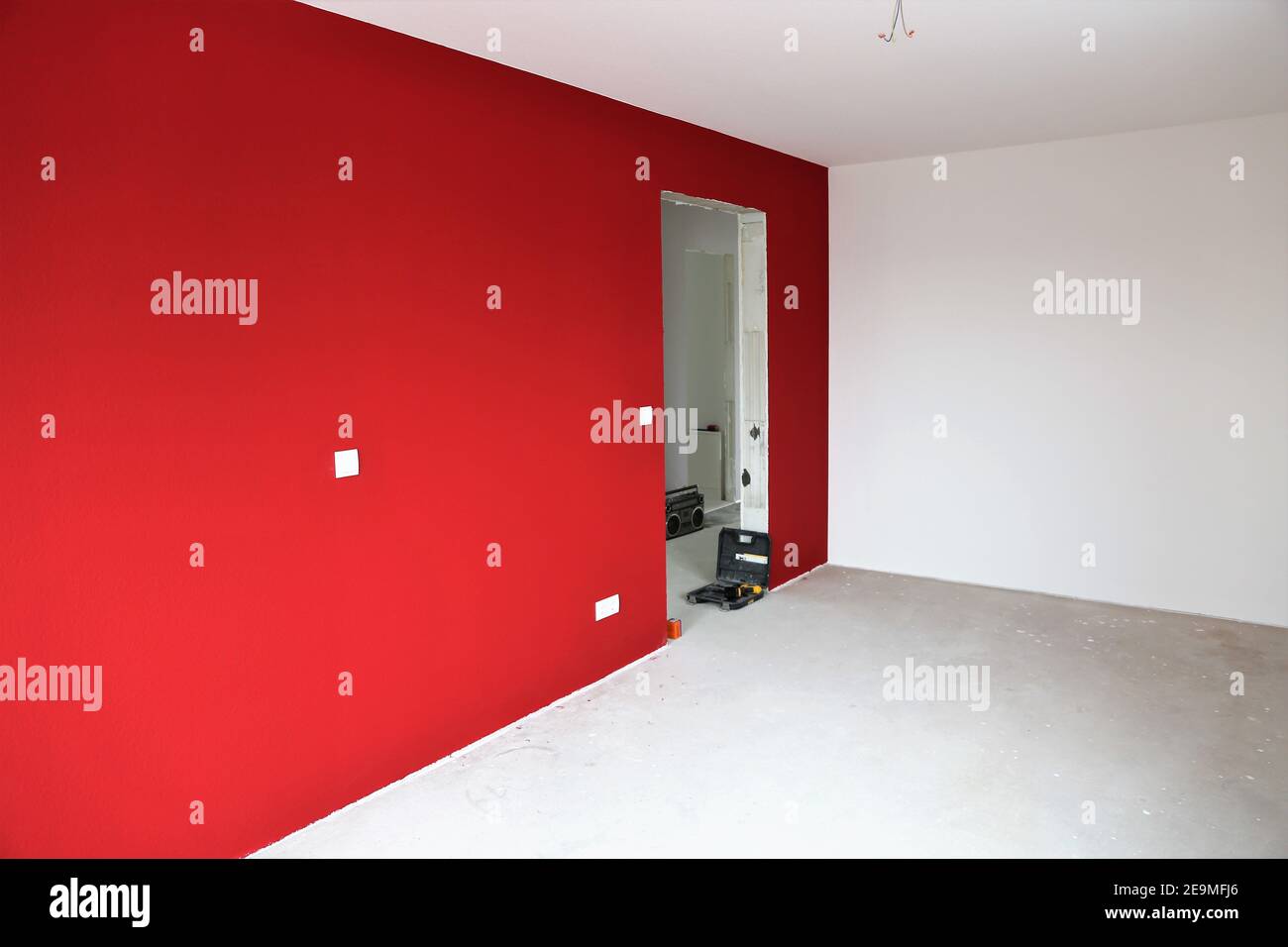 Newly renovated interior with modern red and white wall colors Stock