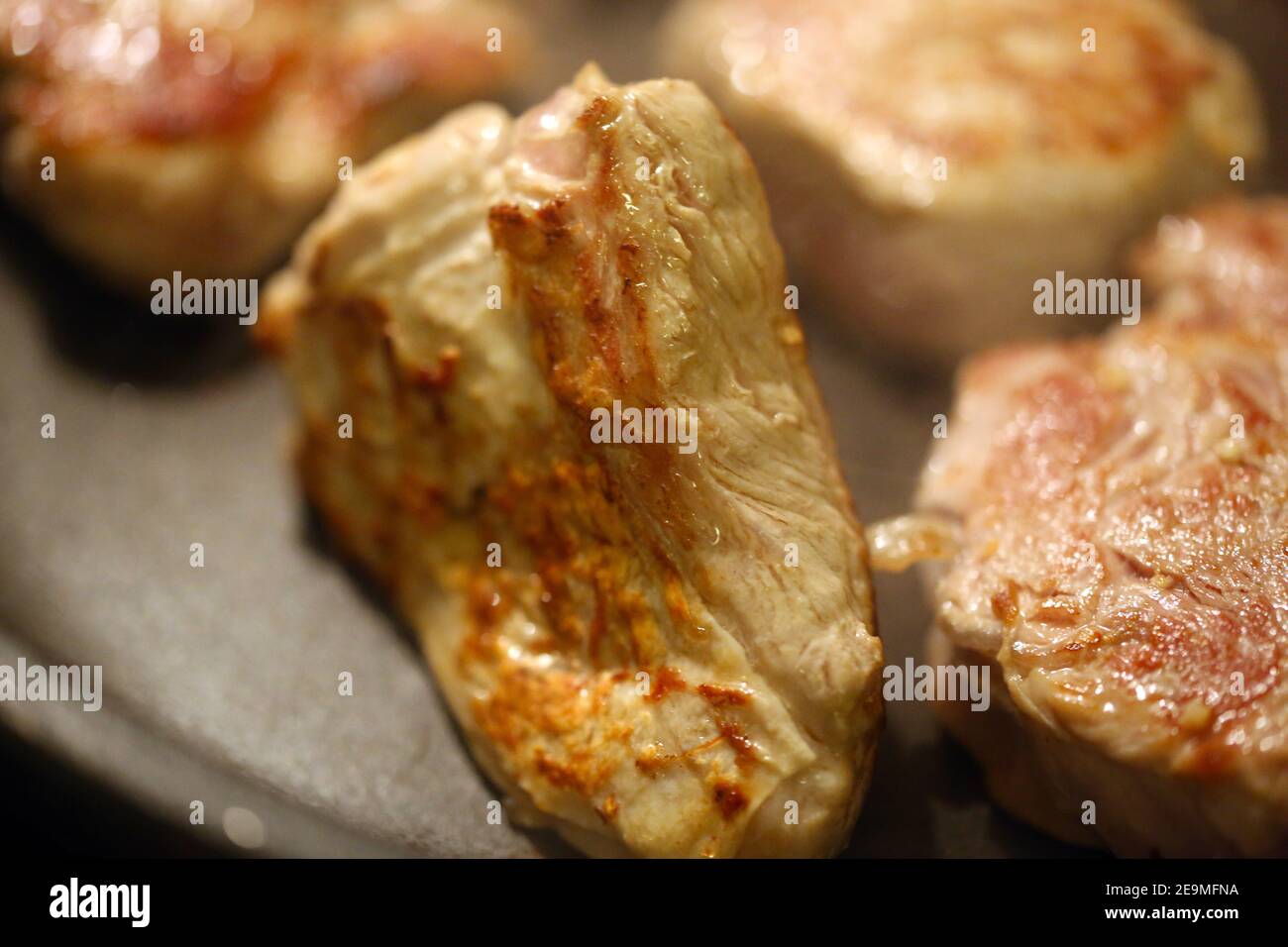 Beef fillet (beef tenderloin) grilling in the frying pan Stock Photo
