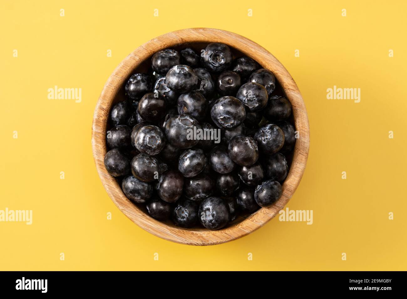 Fresh blueberries on yellow background Stock Photo