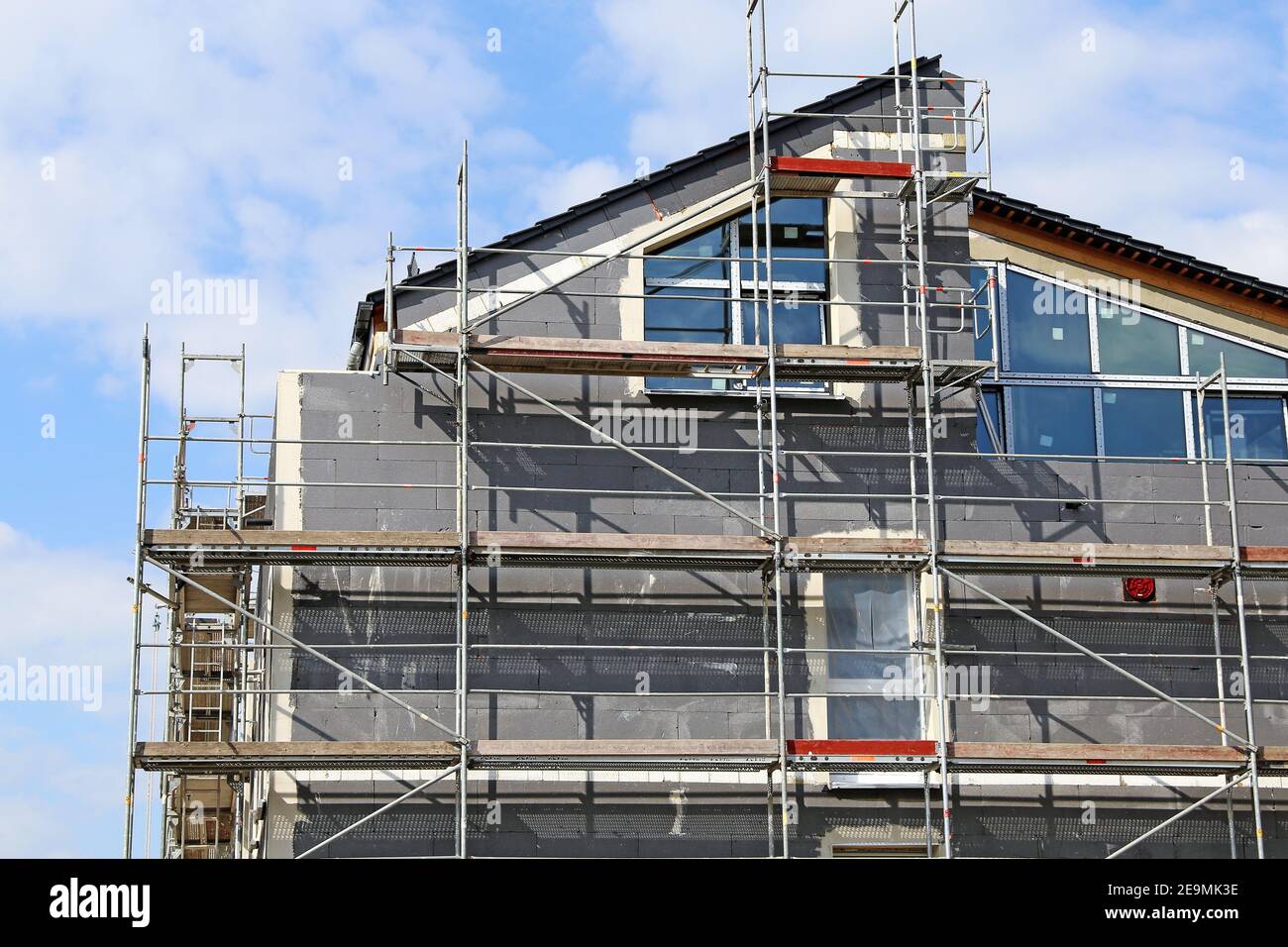 Installation of thermal insulation to a house facade Stock Photo - Alamy