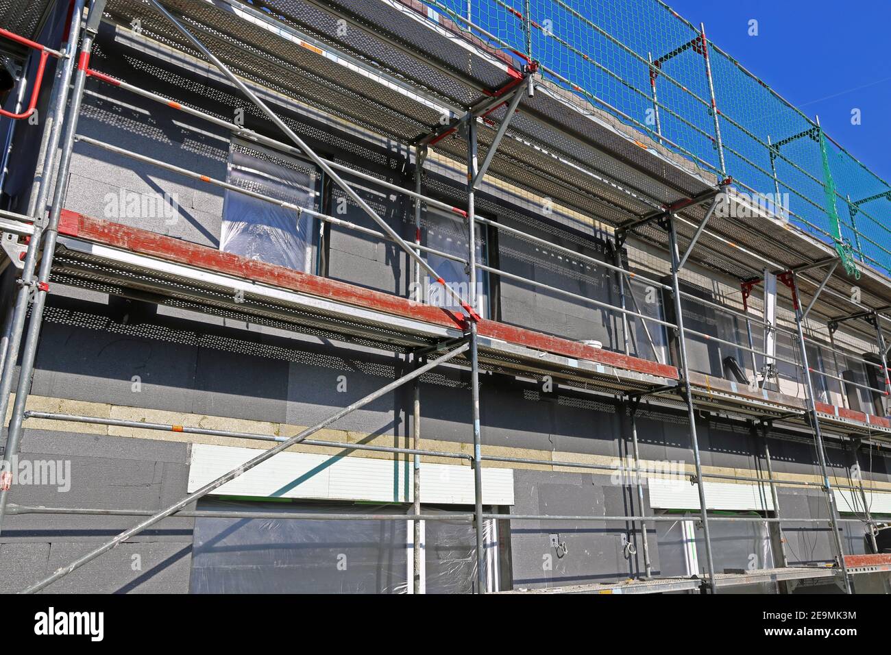 Installation of thermal insulation to a house facade Stock Photo - Alamy