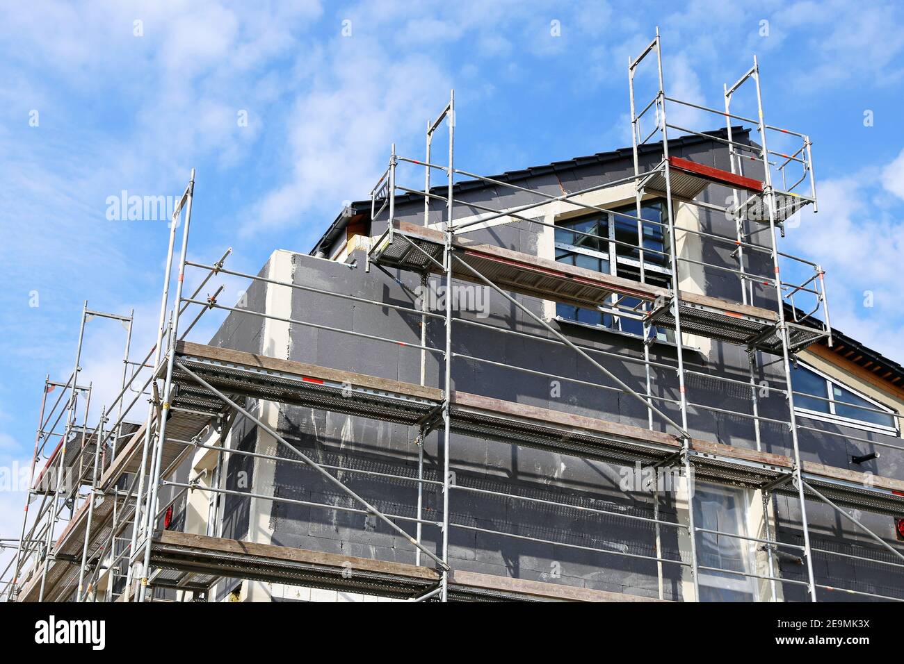 Installation of thermal insulation to a house facade Stock Photo - Alamy
