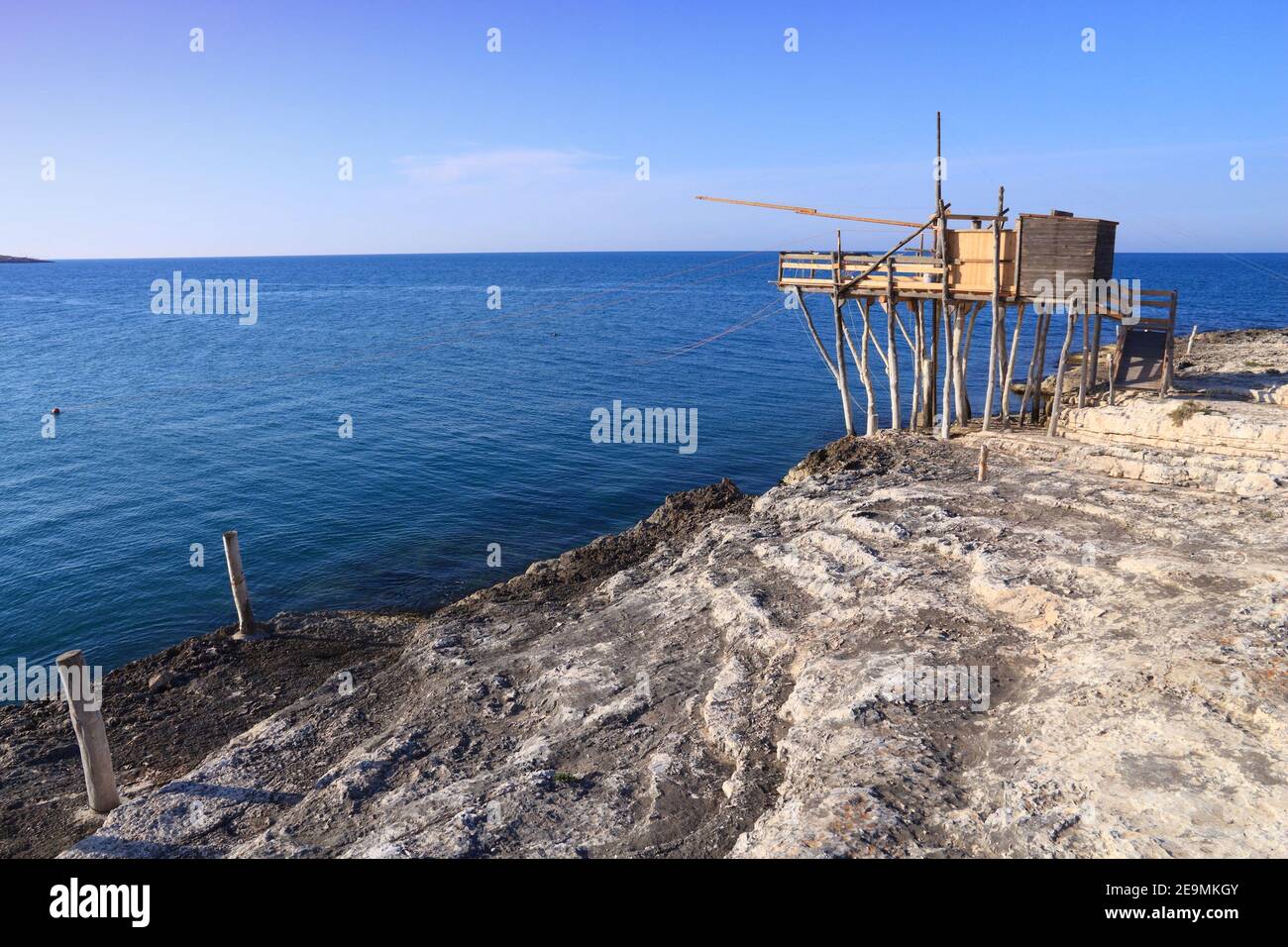 Fishing from the pier or fishing wharf with fishing net and rod at Adriatic  sea in Italy Stock Photo - Alamy