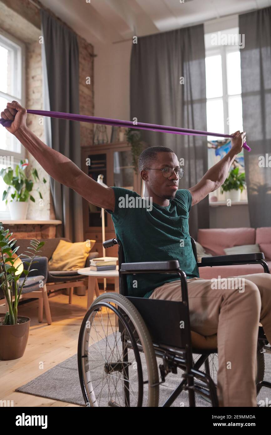 African young man working over his health he exercising during his rehabilitation while sitting in wheelchair Stock Photo