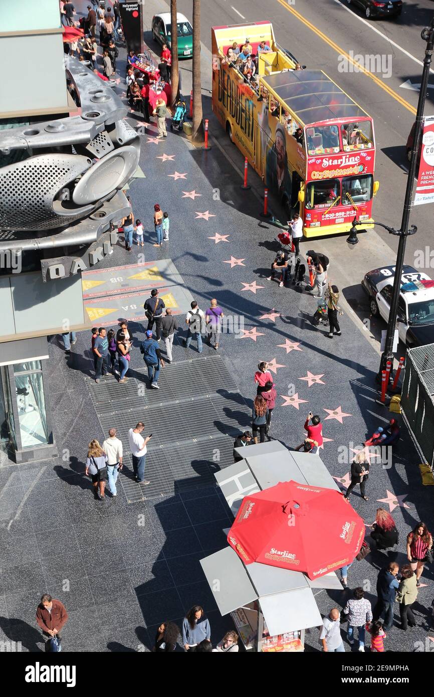 LOS ANGELES, USA - APRIL 5, 2014: People visit Walk of Fame in Hollywood. Hollywood Walk of Fame features more than 2,500 stars with inscribed celebri Stock Photo