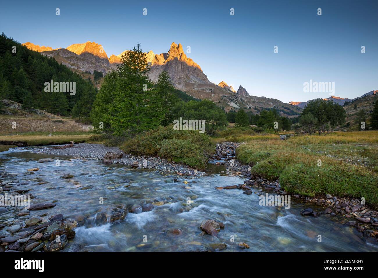 Vallée de la Clarée at sunrise. Alpine torrent. Pointe des Cerces and Roches de Crépin. Névache. Hautes Alpes. France. Europe. Stock Photo