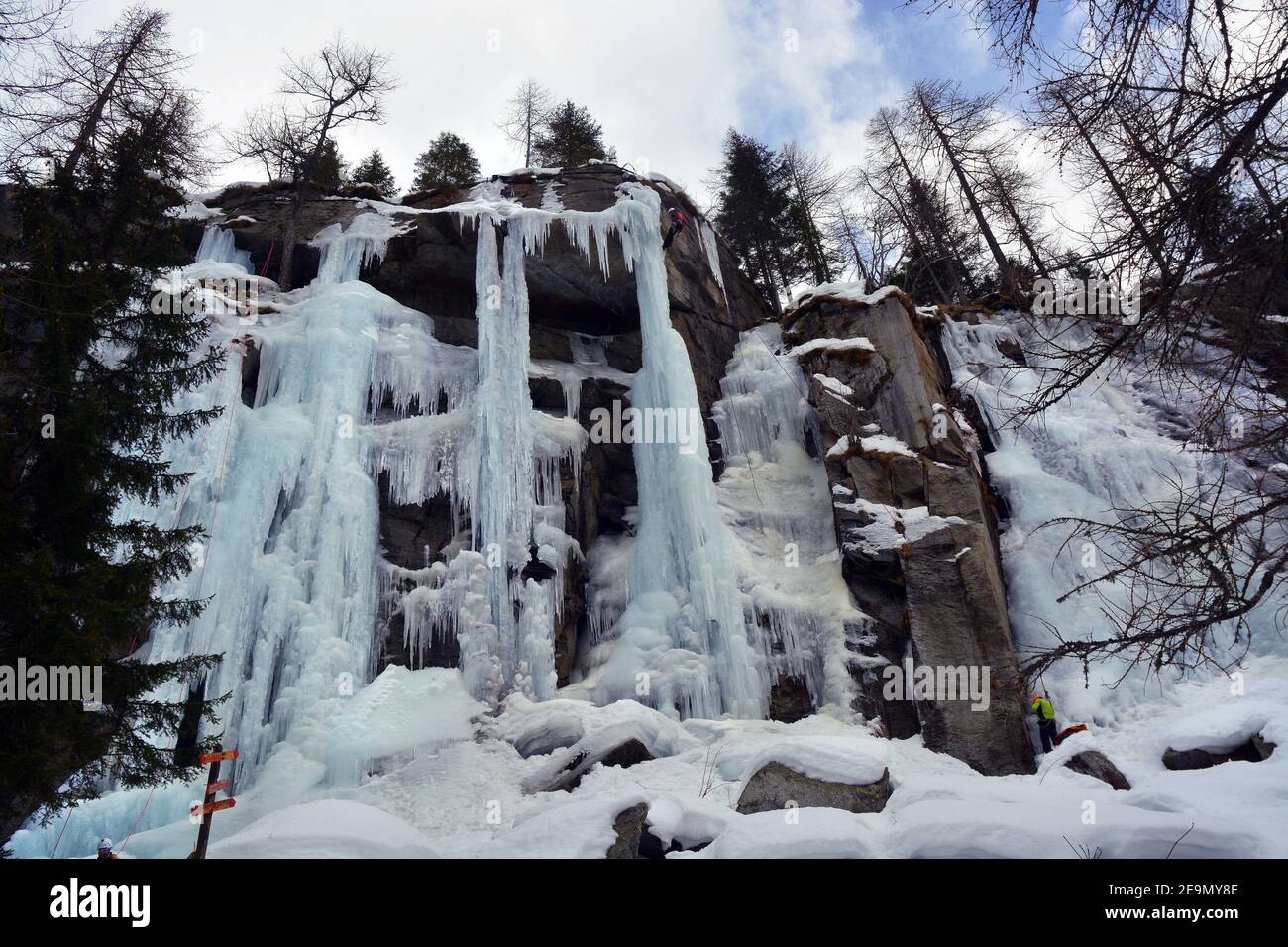 Mountaineer climbs an icefall in Alps of Piedmont, Italy. Stock Photo