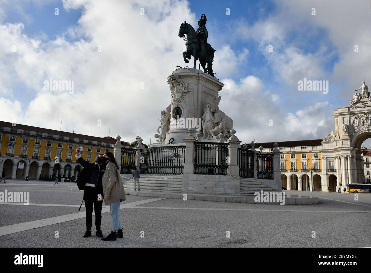 Two women wearing face masks take a selfie near the monument of Pedro I at Praça de Comercio in Lisbon.Portugal has registered 13,740 deaths and 755,774 confirmed cases since the beginning of the pandemic according to the bulletin of the General Health Department (DGS). Stock Photo