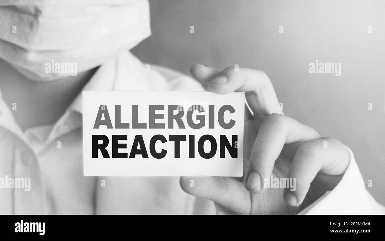 Words allergic reaction on medical card in Doctor's hand. Medicine