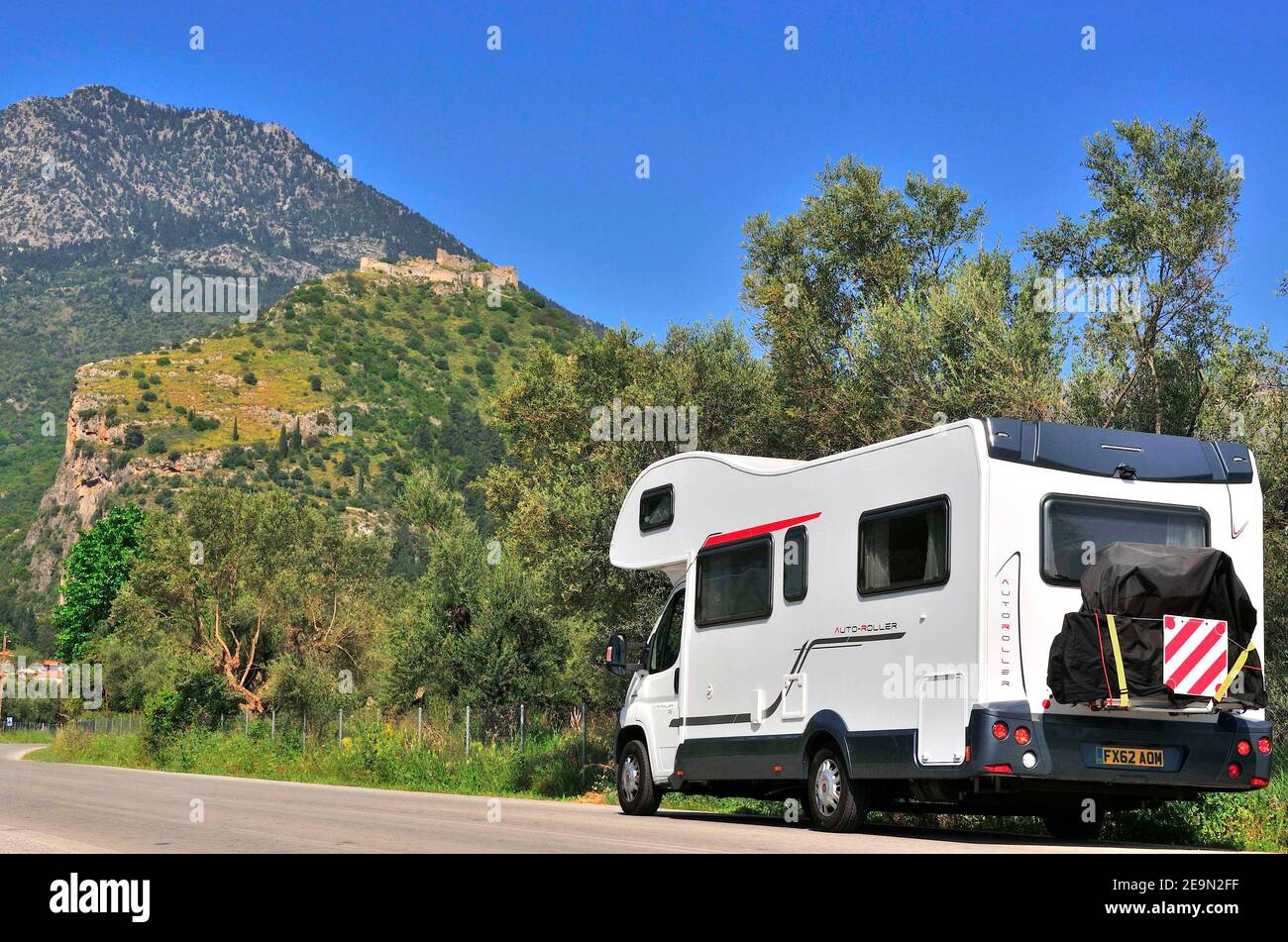 Motorhome on touring holiday driving up to the village of Sparti in the Peloponnese, Greece Stock Photo