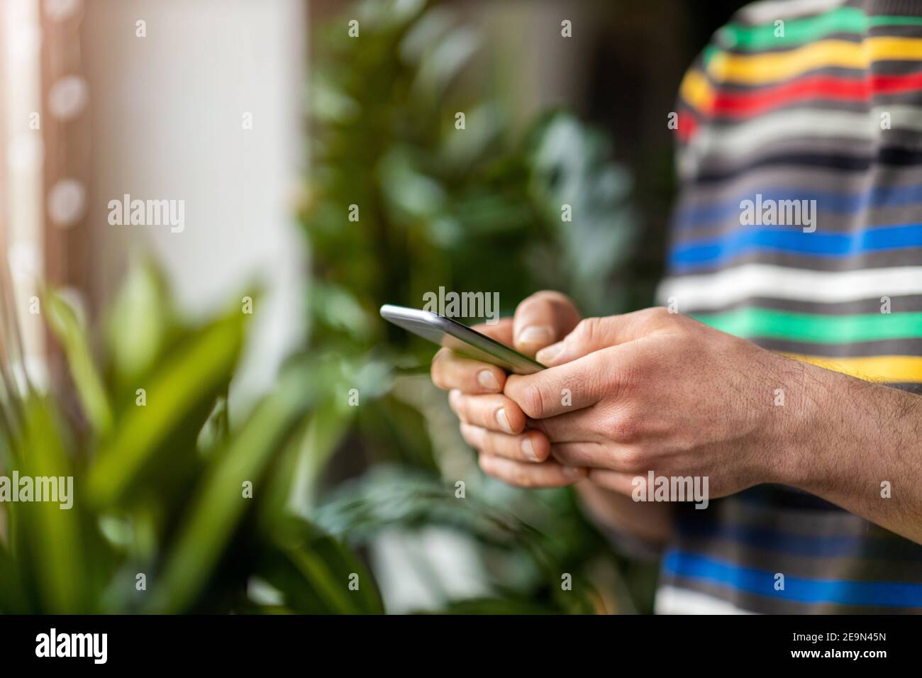 Male hands typing on smartphone Stock Photo