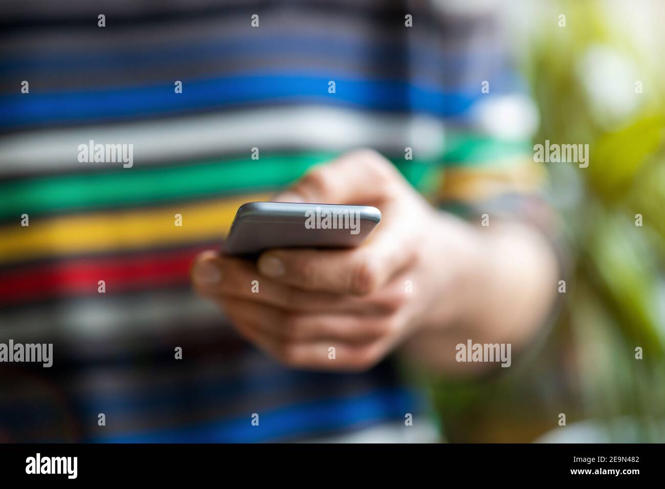 Male hands typing on smartphone Stock Photo