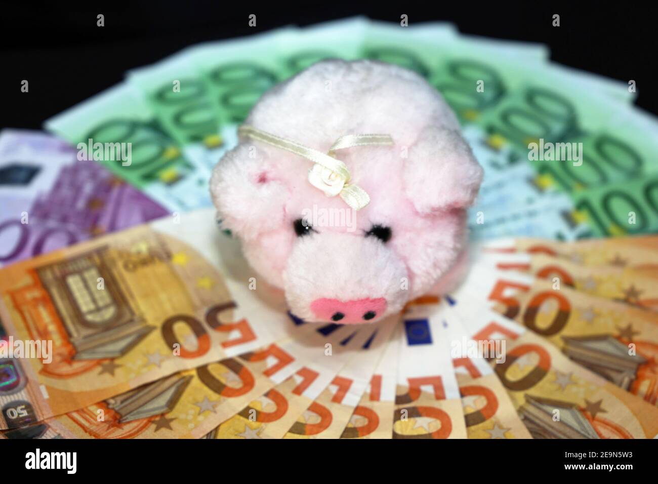 Euro bills (Euro banknotes) with a pig as a good luck symbol in Germany