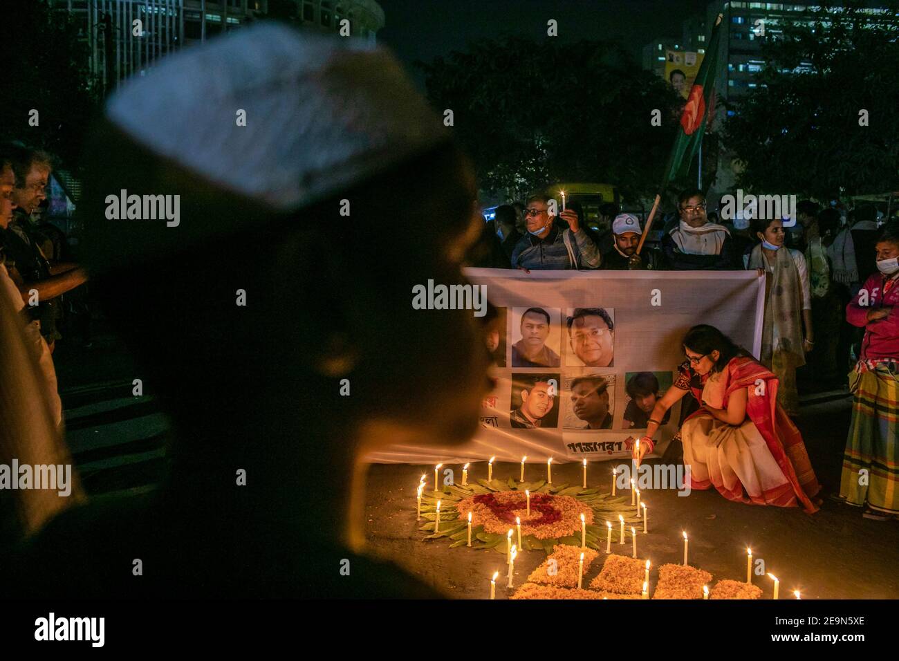 Activists lighting candles during the vigil. Bangladeshi activities in
