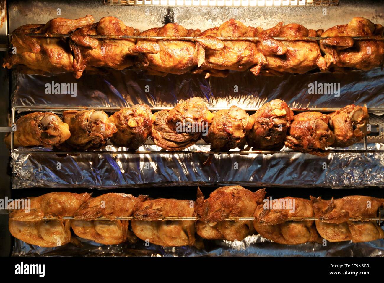 Grilled pork knuckle (roasted pork leg) and roast chicken on the rotary
