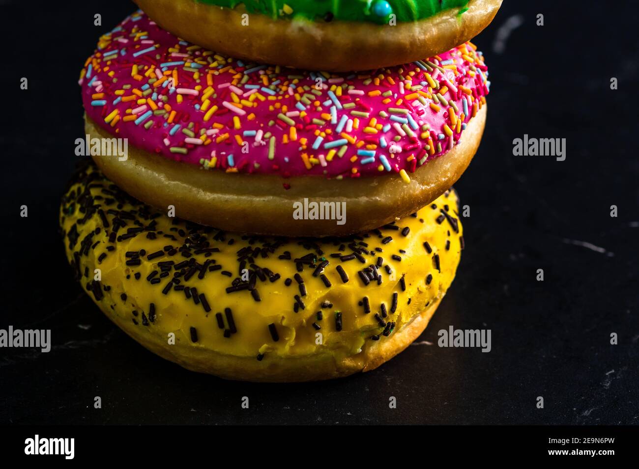 Glazed donuts with sprinkles isolated. Close up of colorful donuts ...