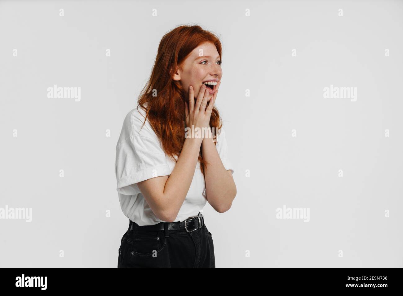Ginger beautiful excited girl expressing surprise isolated over white ...