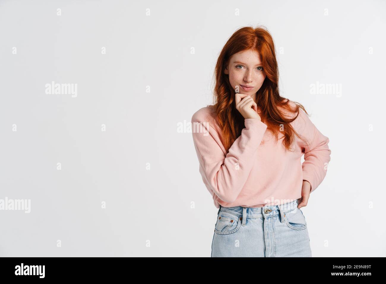 Ginger beautiful pleased girl posing and looking at camera isolated ...