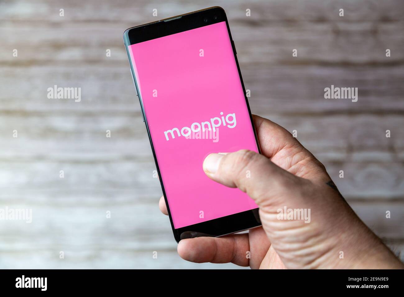A Mobile phone or cell phone being held showing the Moonpig app open on
