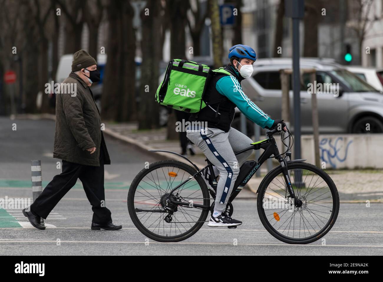 A Uber Eats courier wearing a face mask as a precaution against 