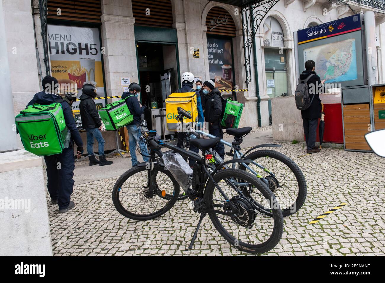 A group of Uber Eats and Glovo couriers seen waiting to pick up 