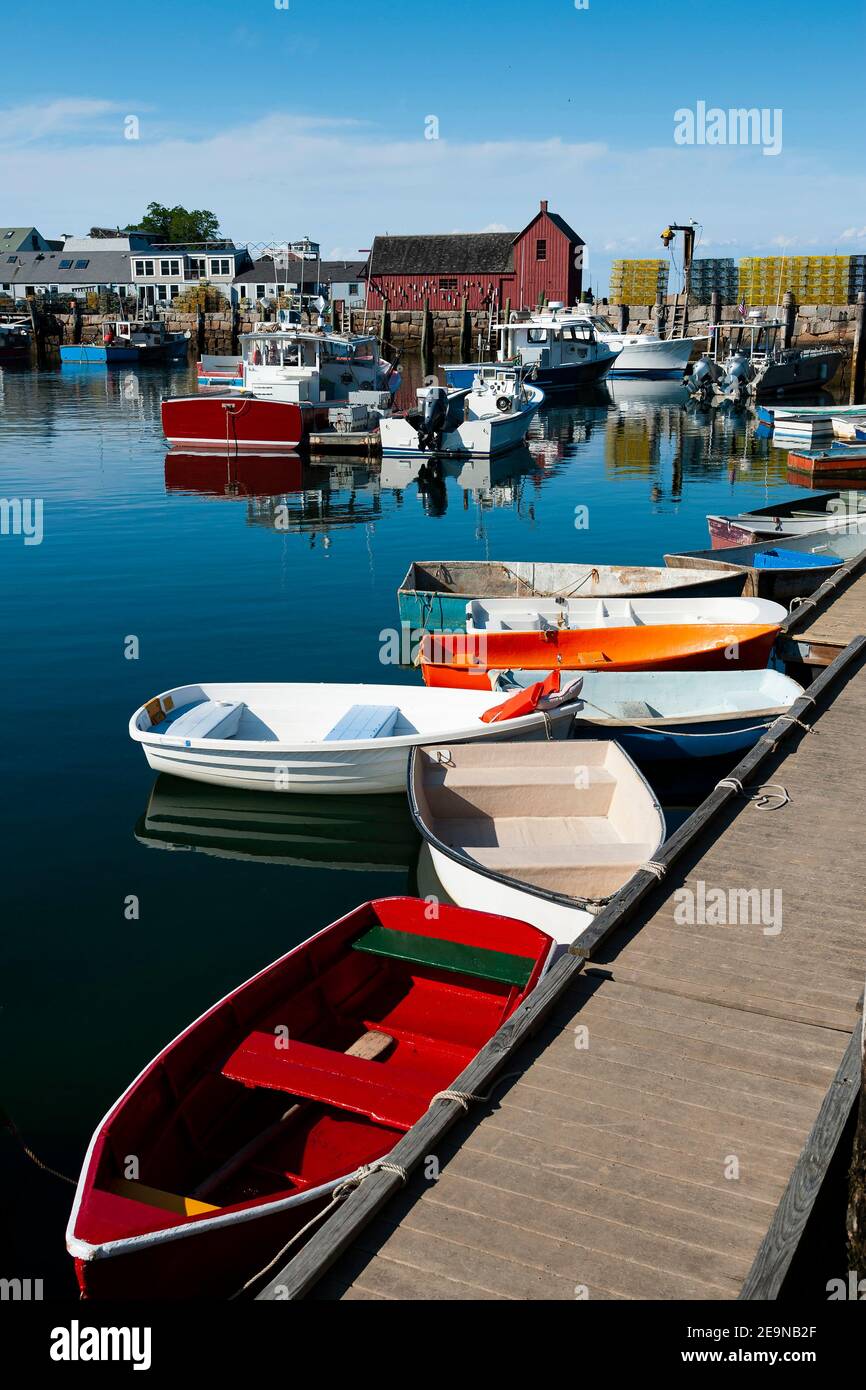 Colorful rowboats inside famous Bradley Wharf moored by popular red fishing shack, known to artists as Motif #1, in Rockport Harbor in Massachusetts. Stock Photo