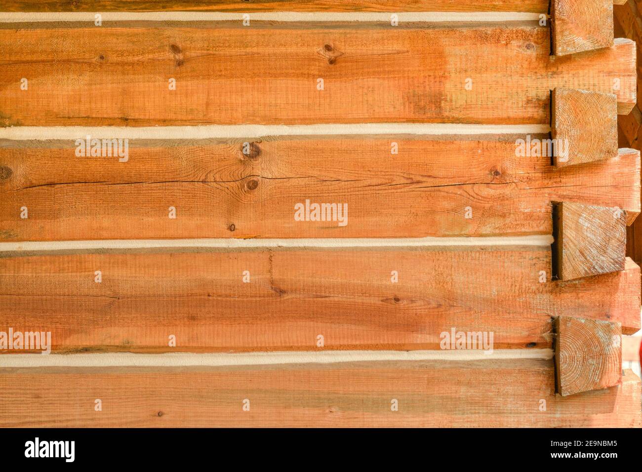 Corner of a house built with timber bars Stock Photo