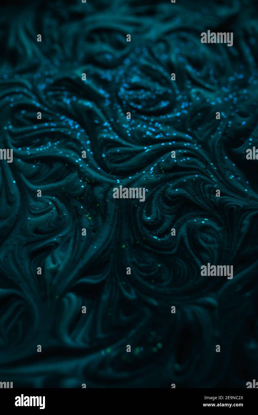 Smooth marbling mixed liquid paint texture with glitter. Abstract drammatic dark texture with fluid art effect Stock Photo