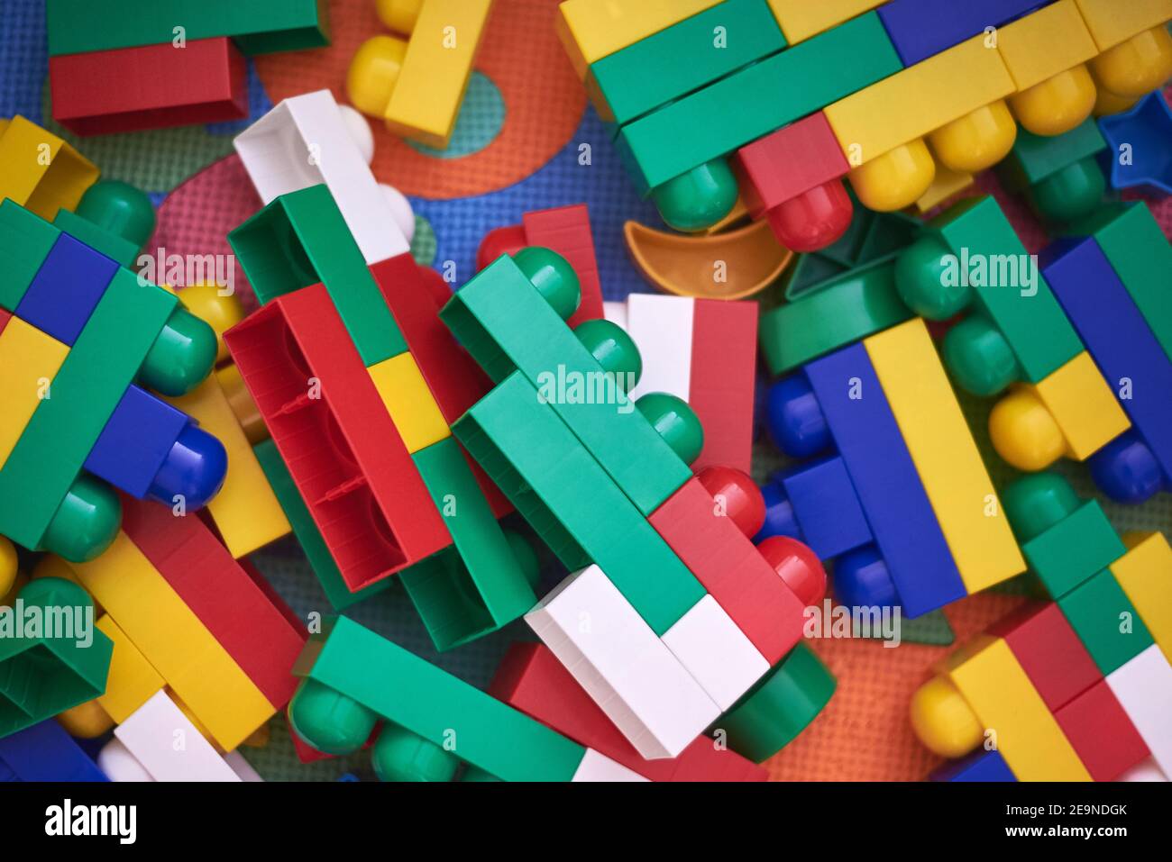 Children's large multi-colored constructor scattered on the floor. Stock Photo