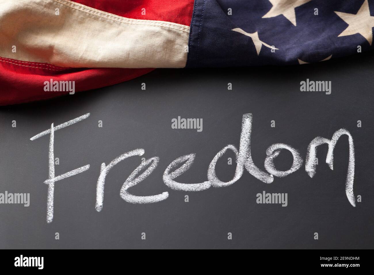 Freedom sign on a chalkboard with vintage American flag Stock Photo