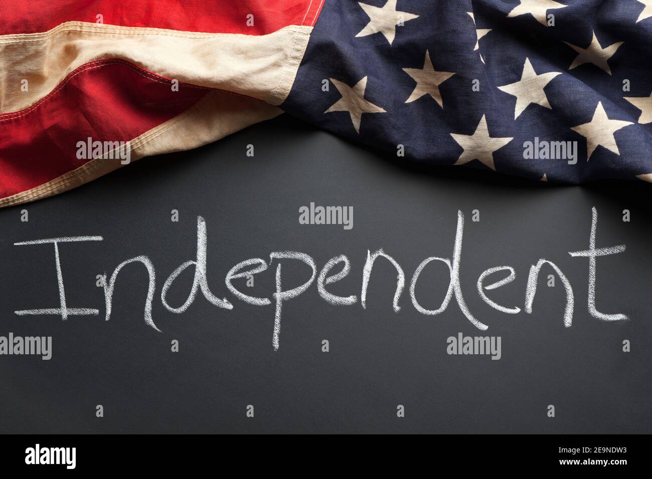 Independent political party sign written on a chalkboard with vintage American flag Stock Photo