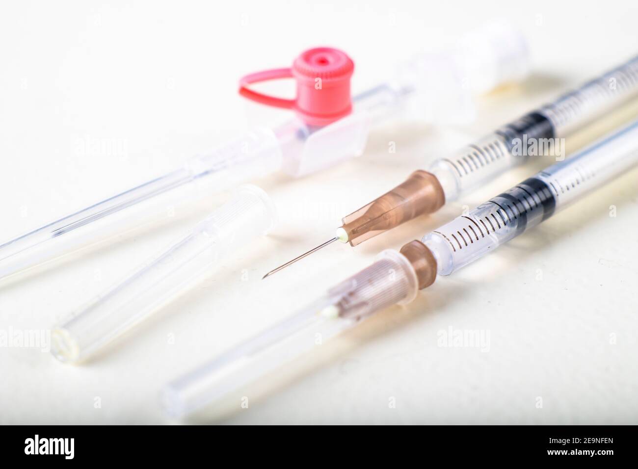 Medical syringes and cannula. Hospital treatment accessories. Light background. Stock Photo