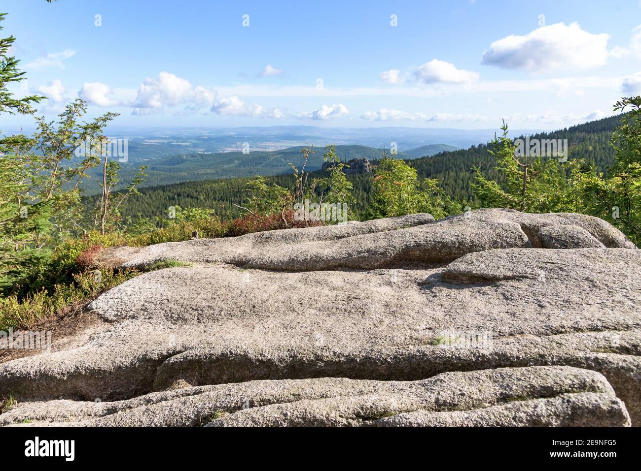 View of rock formations in polish Giant mountains with Jelenia Gora town in the background Stock Photo