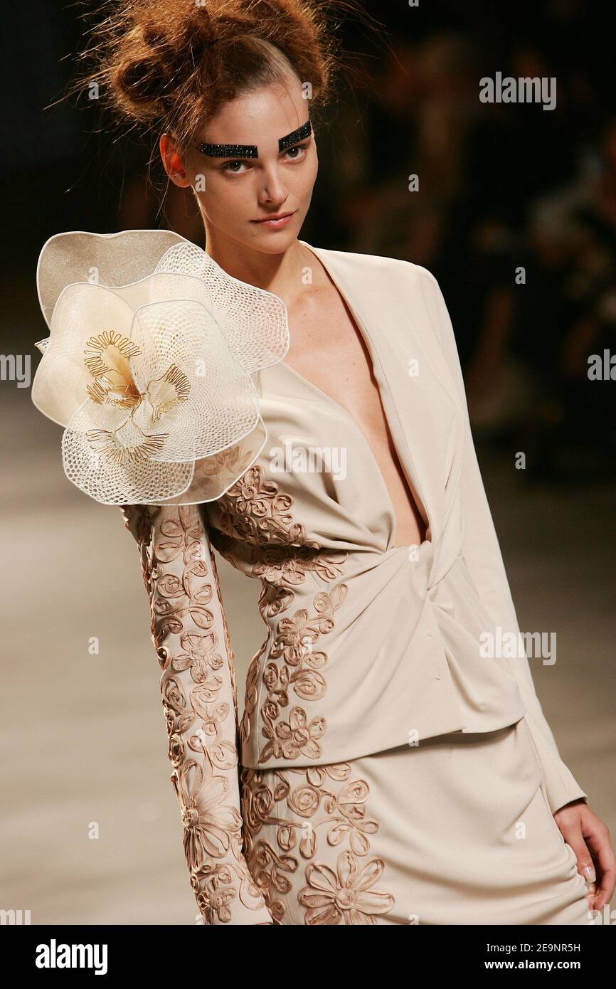 A model displays a creation by British fashion designer John A model displays a creation by British fashion designer John