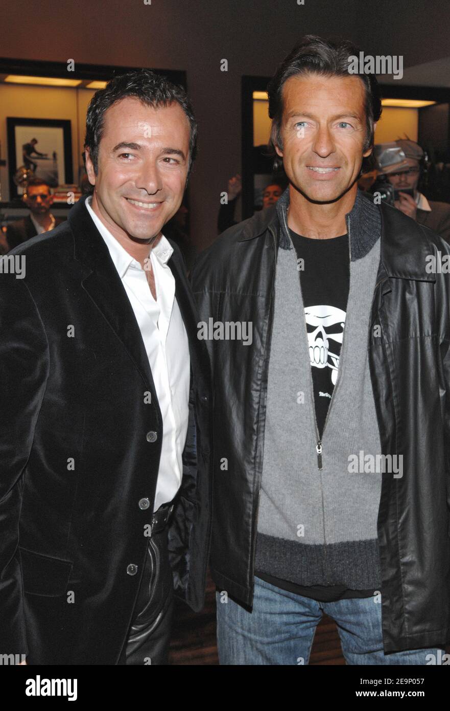 French anchors Bernard Montiel and Alexandre Debanne pose during the  opening party for Tommy Hilfiger's flagship store in Paris, France, on  October 18, 2006. The store, located on the famous 'rue St