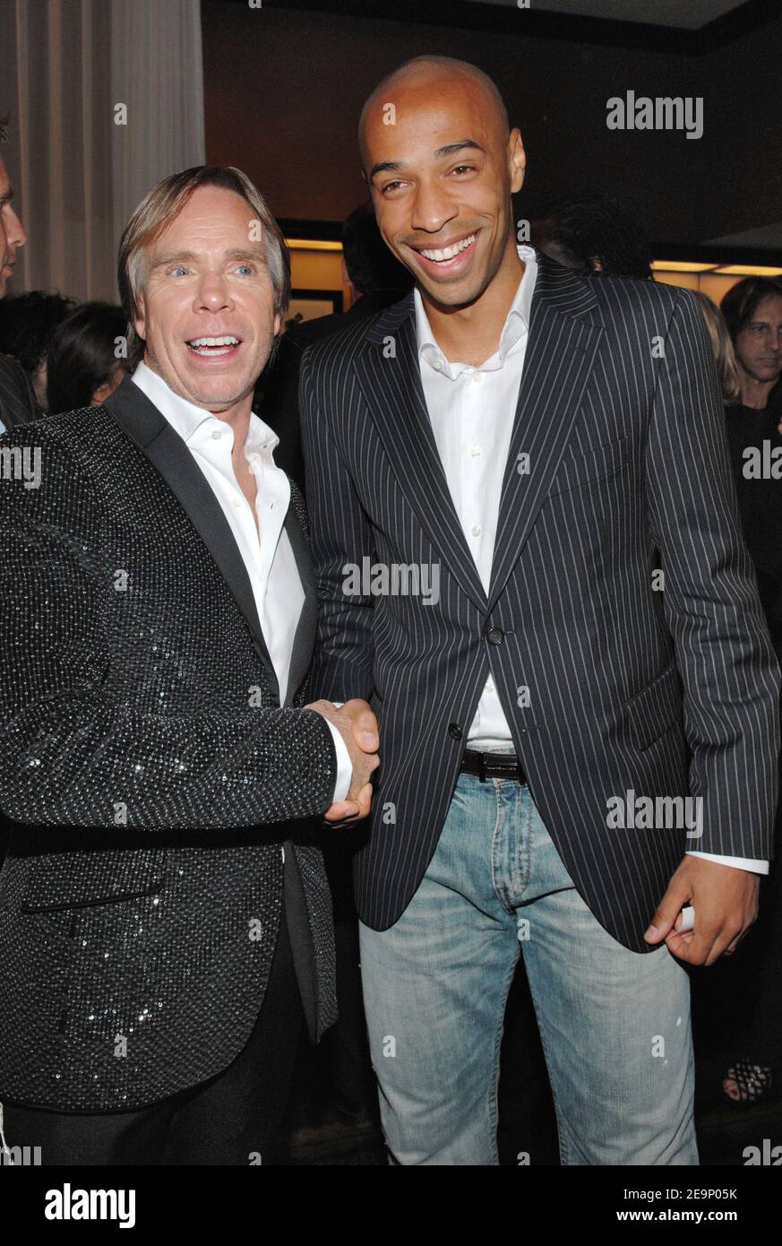 US Fashion designer Tommy Hilfiger poses with French soccer superstar Thierry  Henry during the opening party for Tommy Hilfiger's flagship store in  Paris, France, on October 18, 2006. The store, located on