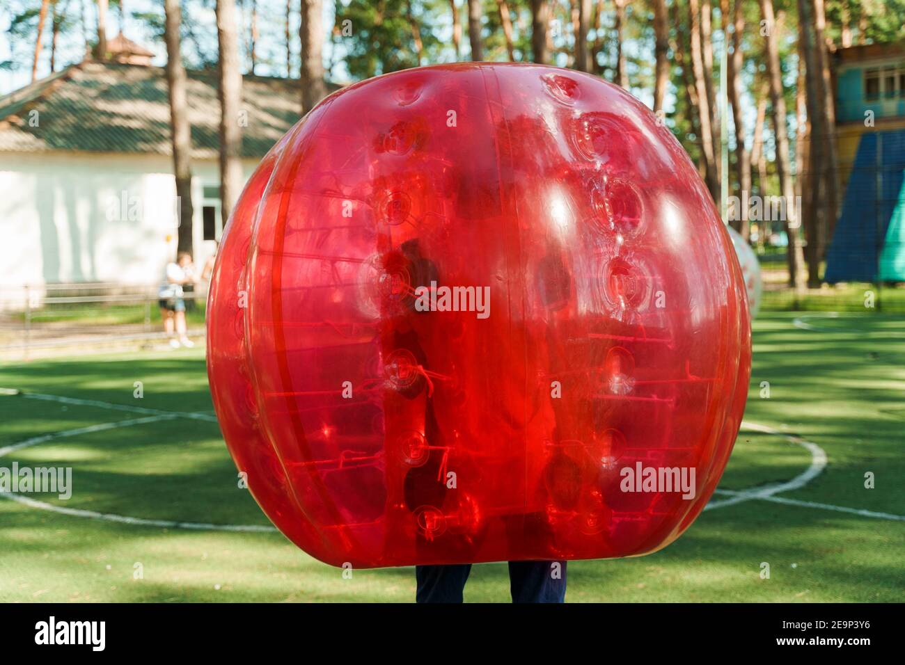 Bubble football sport game. Football players play bumperball on the