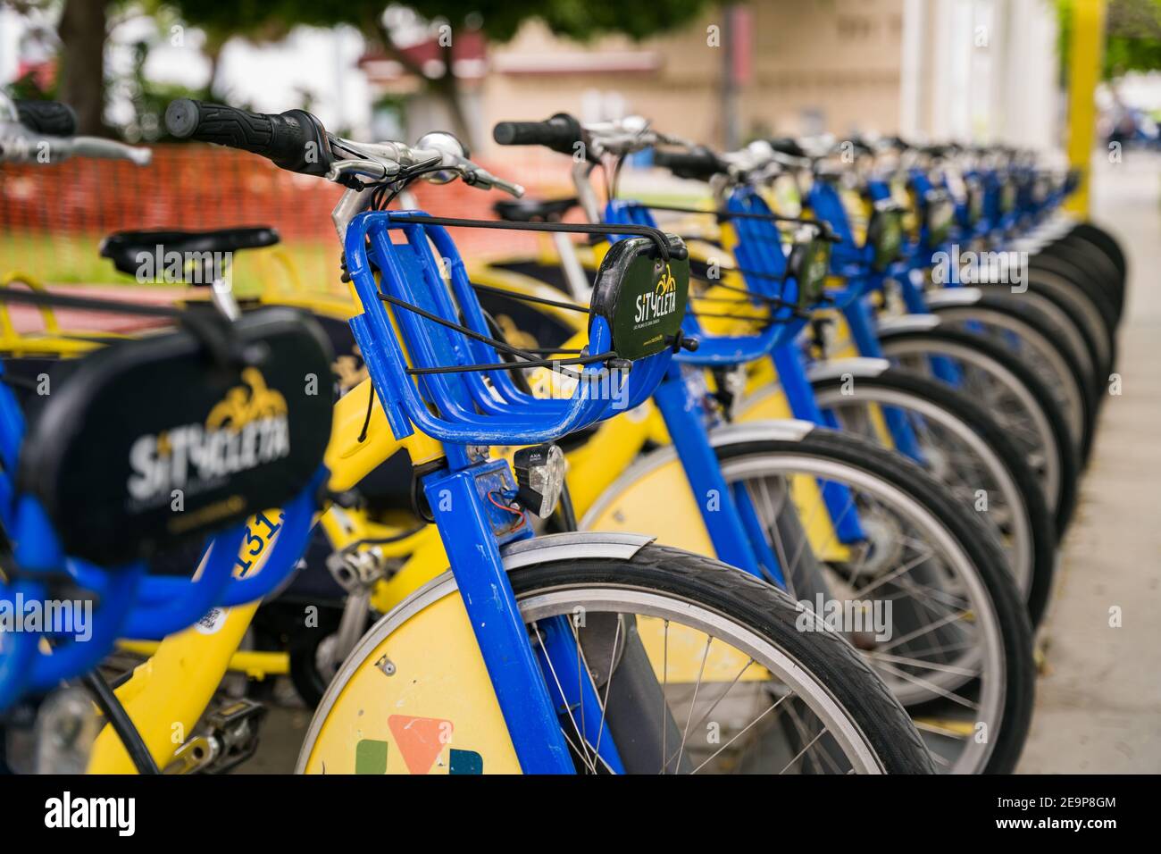 Las Palmas, Spain - August 8, 2020. Close up of handlebar. Group of many public city bicycles parked in rack row. Smart eco friendly transport Stock Photo