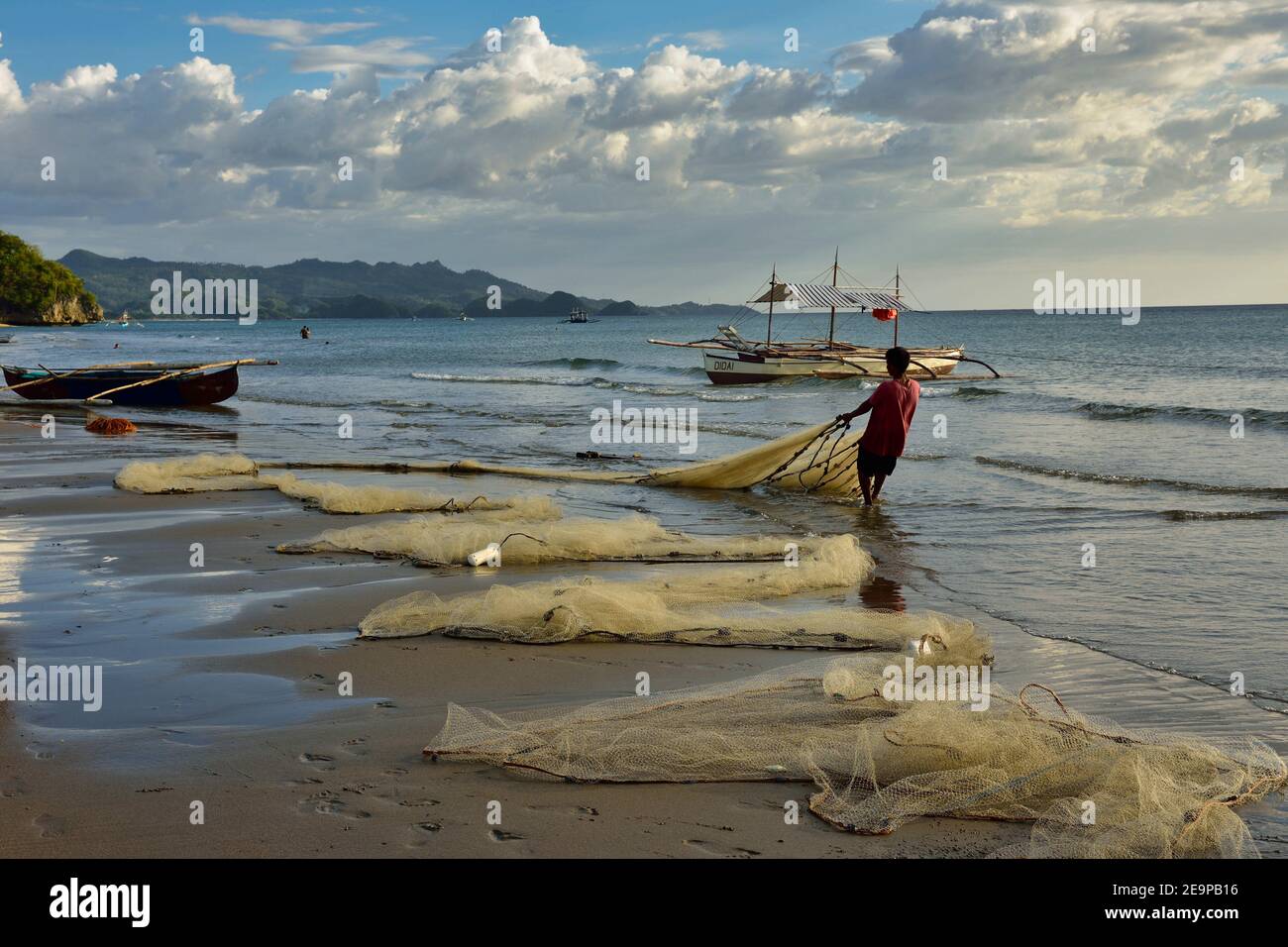 Filipino Fishermen is fishing on the shore in the Philippines Stock Photo
