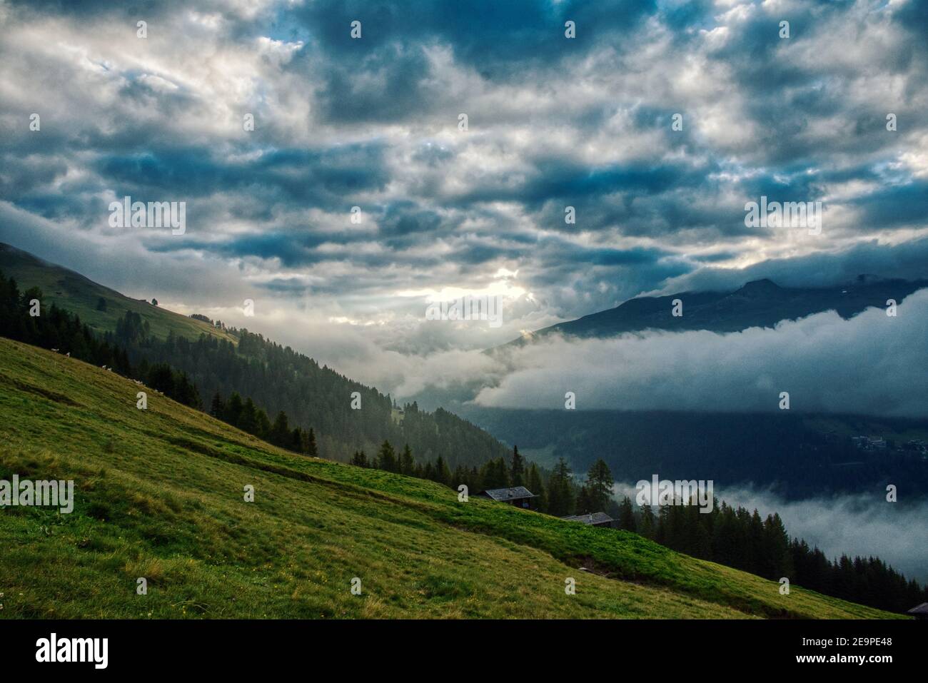 dramatic weather mood in the mountains. Green lush meadows, davos graubunden swiss Stock Photo