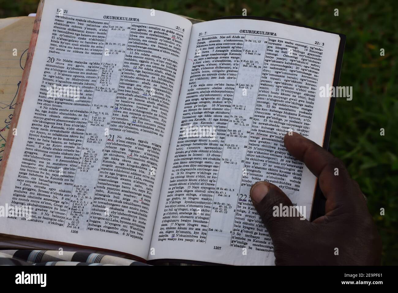 Swahili Bible with hand and finger on the bible from an african men Stock Photo
