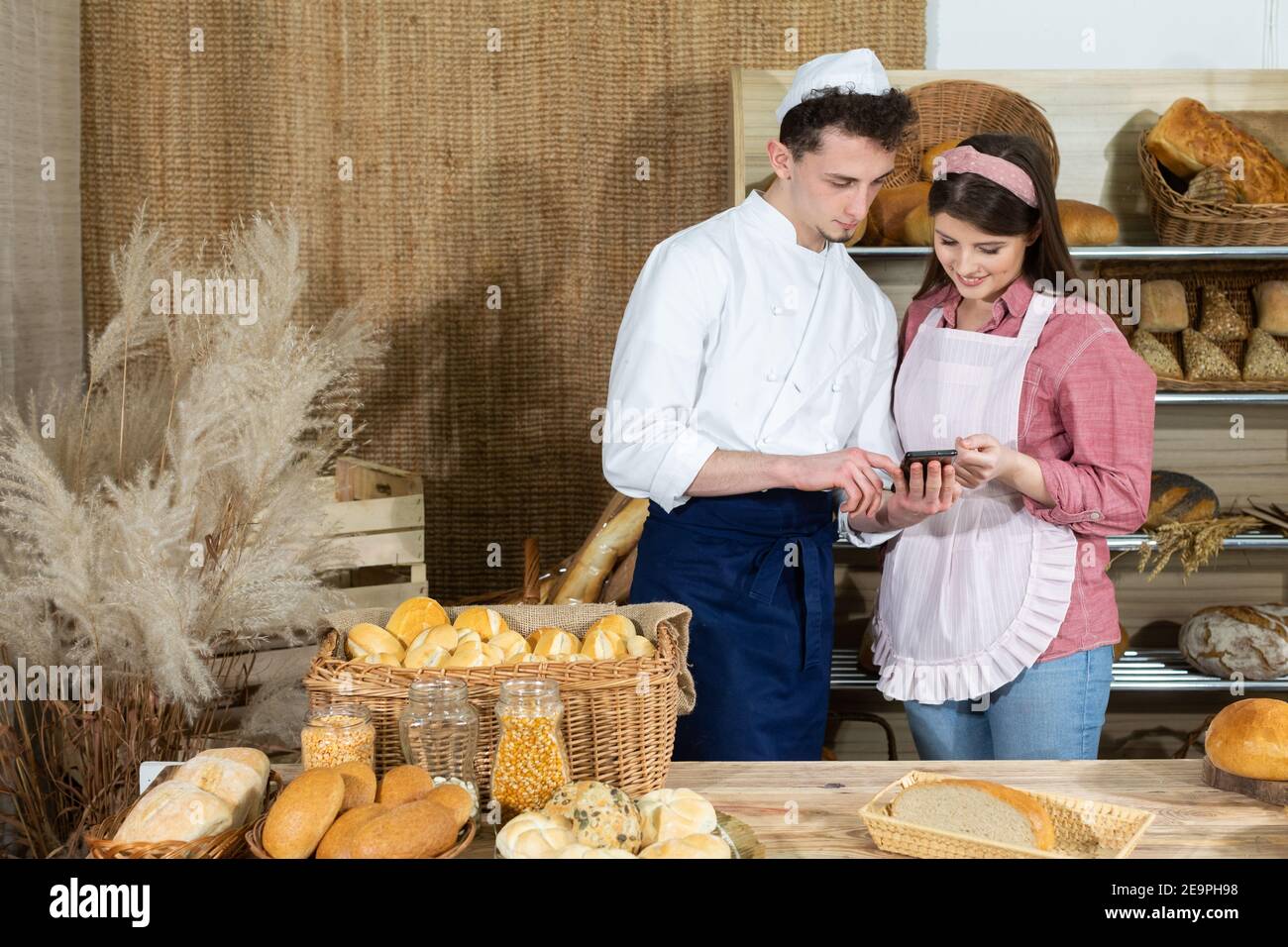 During the sales break, the baker shows the young expeditioner photos of the bread he intends to