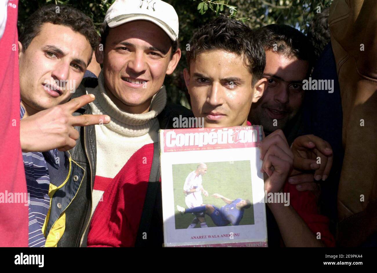 French soccer star Zinedine Zidane's Algerian fans hold a picture of him after he head-butted Italian player Marco Materrazzi during the Wolrd Cup Soccer 2006 Finale in Sidi Saoud, Algeria on December 11, 2006. Zidane came by a private jet for a four days visit in his parents'home country. Photo by Reda Guelmani/ABACAPRESS.COM Stock Photo